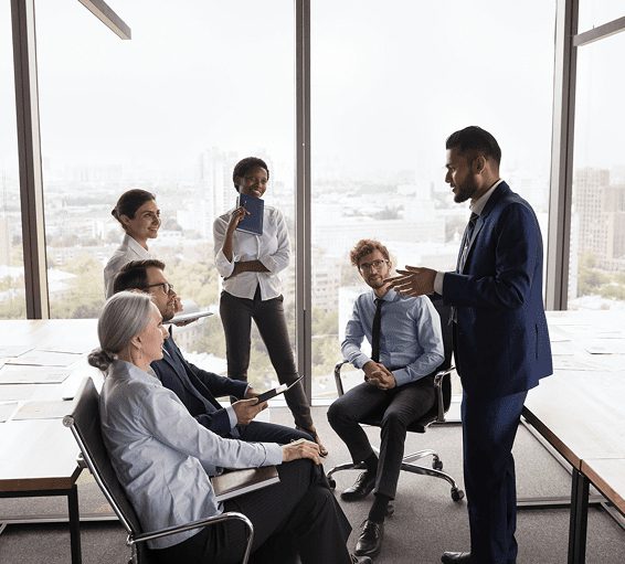 A group of professionals engaged in a discussion in a modern office.